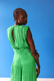 The celeste jumpsuit drapes elegantly down the body in a green-toned zebra print. The cinched in waist provides a form fitting silhouette.