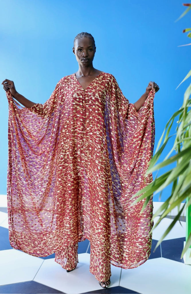 The Afet Pants feature a ruby red and beige cheetah print pattern. Several shades of brown are used to bring this pattern to life.