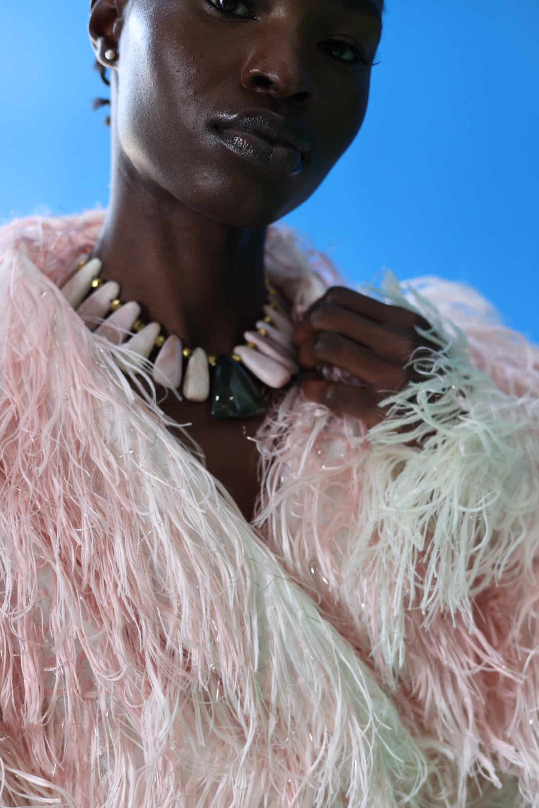 The Shaggy Brigitte Coat has an ombre effect from light pink to creamy white. The pastel pink and sparkles will have you feeling like a princess.