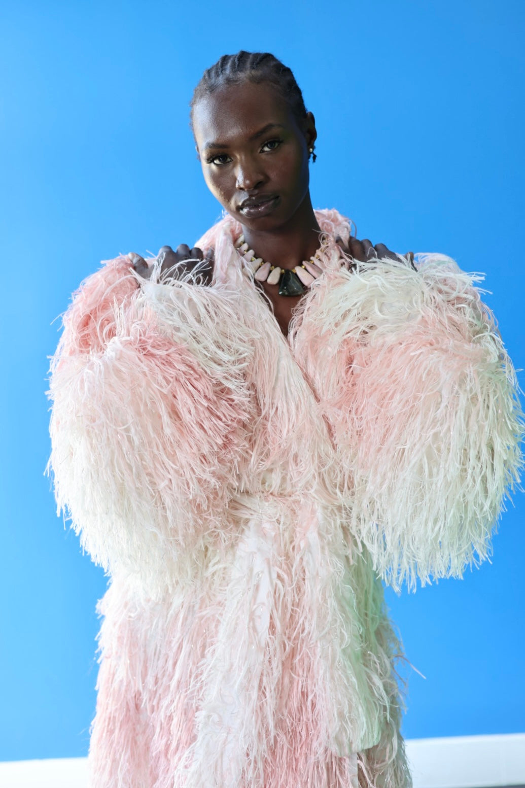 The Shaggy Brigitte Coat has an ombre effect from light pink to creamy white. Feel secure with the matching belt.