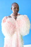 The Shaggy Brigitte Coat has an ombre effect from light pink to creamy white. Stay cozy and cute.