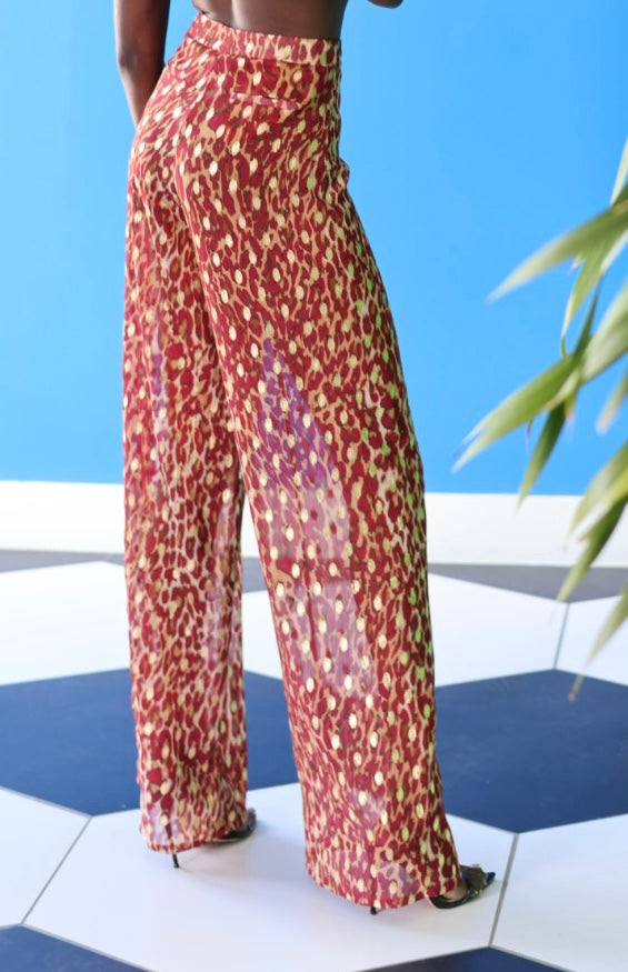 The Afet Pants feature a ruby red and beige cheetah print pattern. The zipper and clasp ensure that you get a nice, fitted look.