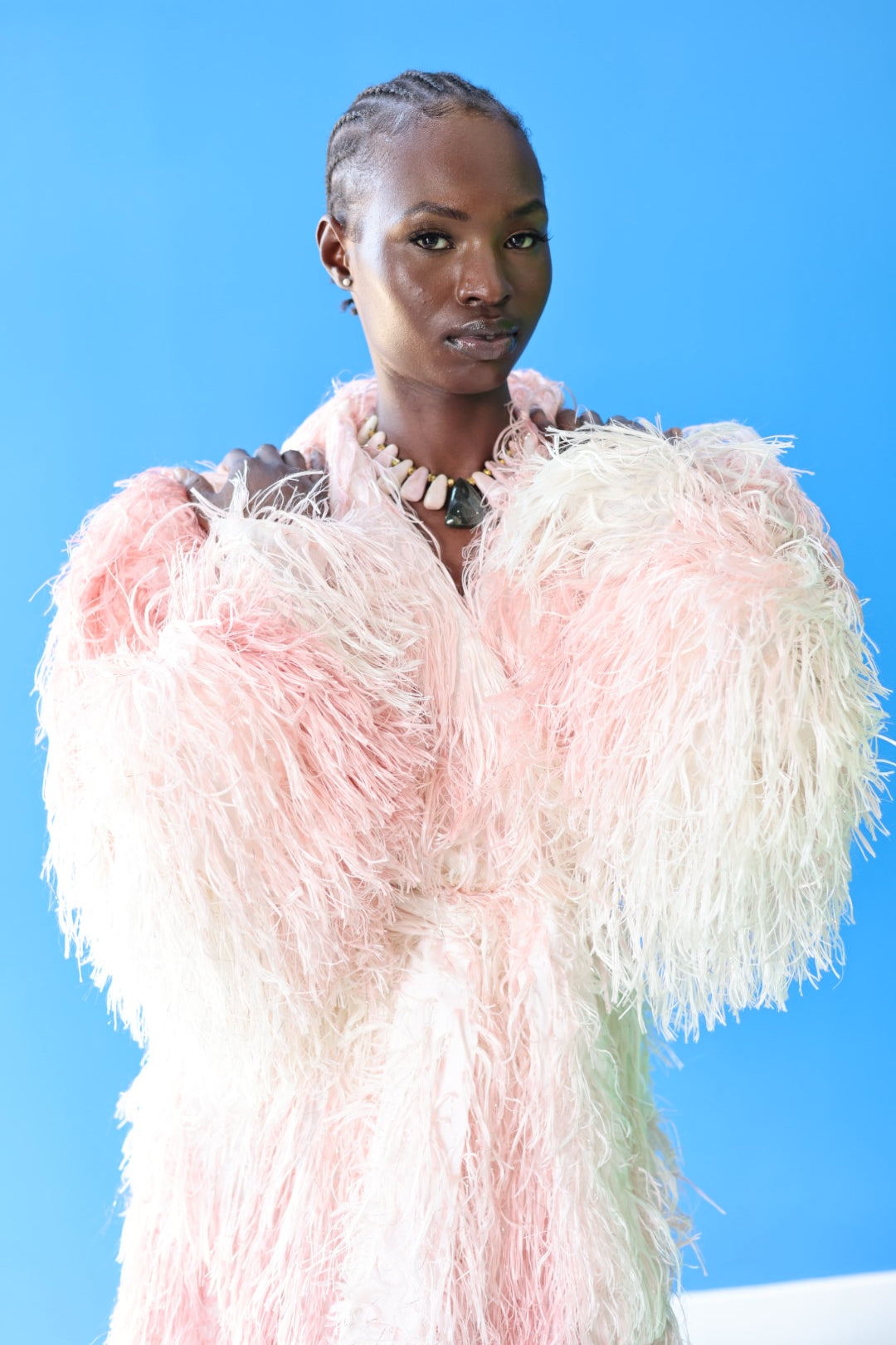 The Shaggy Brigitte Coat has an ombre effect from light pink to creamy white. Stay cozy and cute.