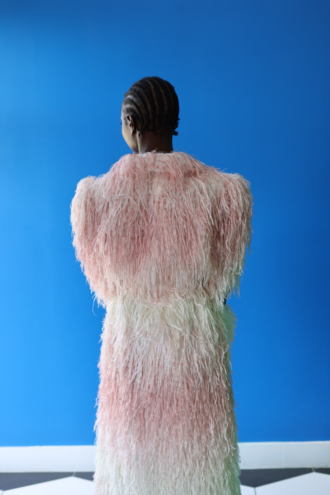 The Shaggy Brigitte Coat has an ombre effect from light pink to creamy white. Look just as good from the back as you do from the front with the dramatic sleeve and form flattering belt.