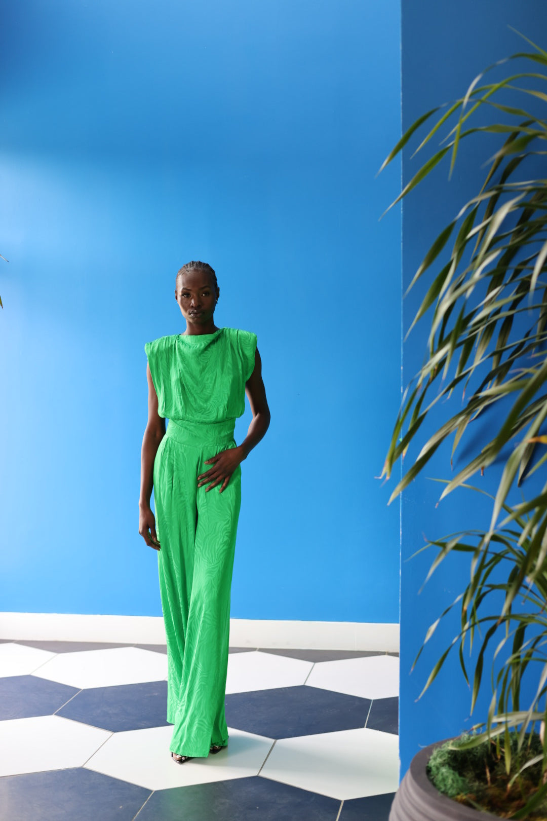 The celeste jumpsuit drapes elegantly down the body in a green-toned zebra print. Her high neckline exudes modesty without compromising the look.