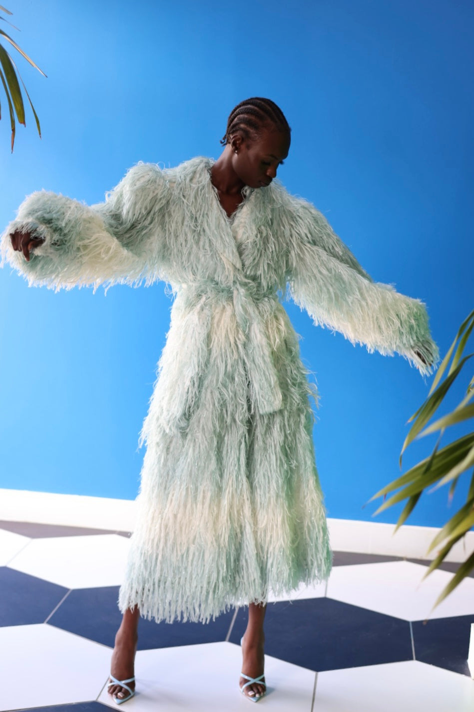 The Enola Shaggy Coat has an ombre effect from light blue to creamy white. The lantern sleeves add an element of grandeur.