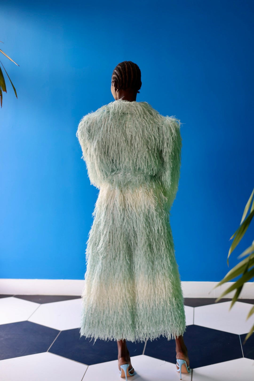 The Enola Shaggy Coat has an ombre effect from light blue to creamy white. The defined shoulder and cinched waist make for a powerful silhouette.
