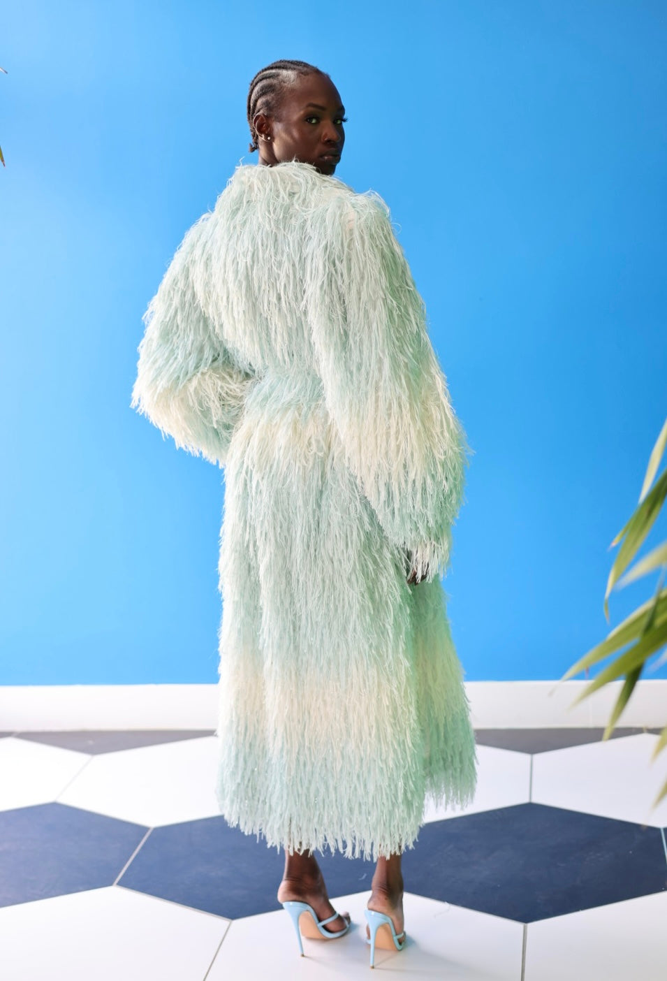 The Enola Shaggy Coat has an ombre effect from light blue to creamy white. The lantern leaves and belt offer a playful feel to the wear of this coat.