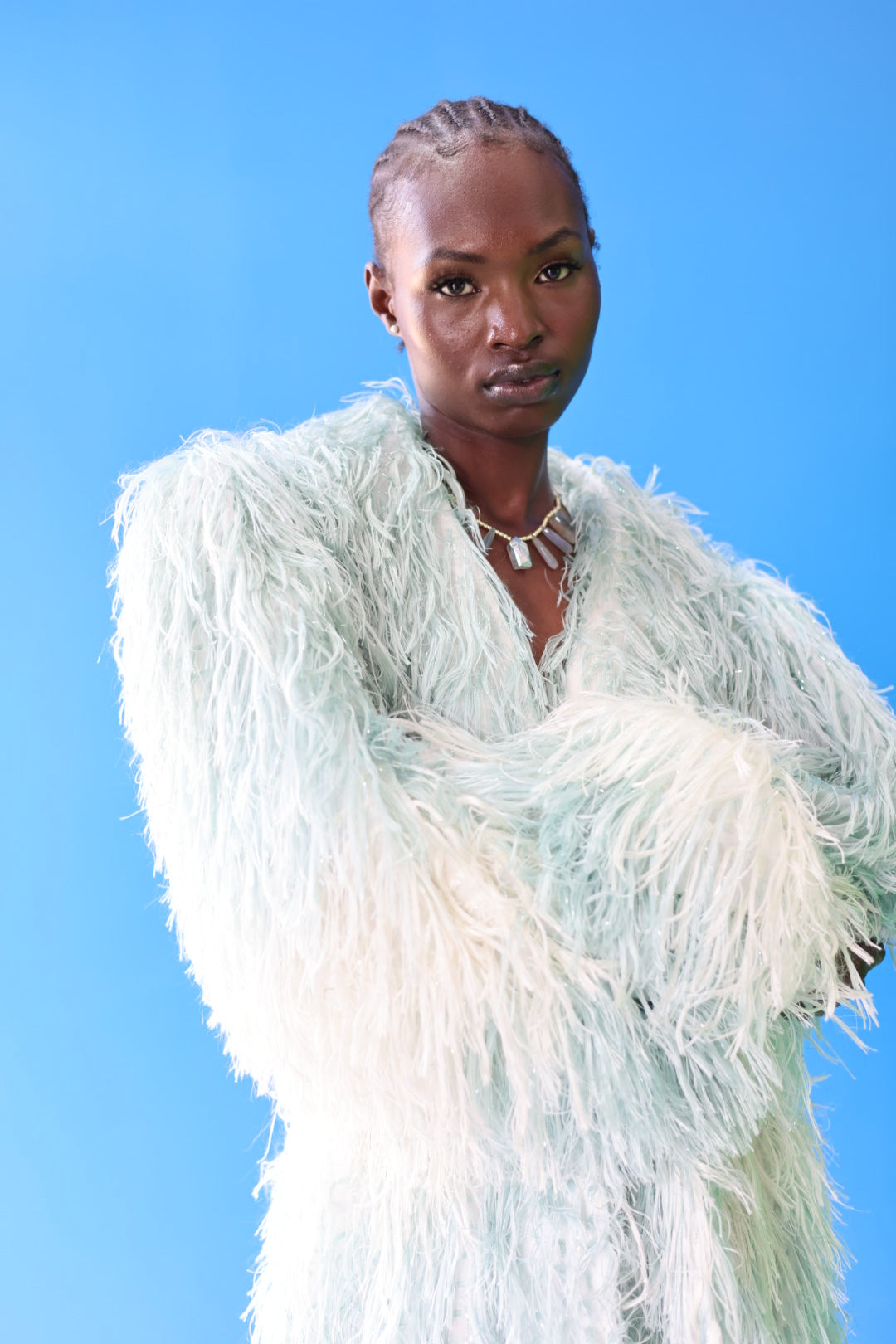 The Enola Shaggy Coat has an ombre effect from light blue to creamy white. Personalize this coat by tying it however you want and styling it with your favorite jewelry.