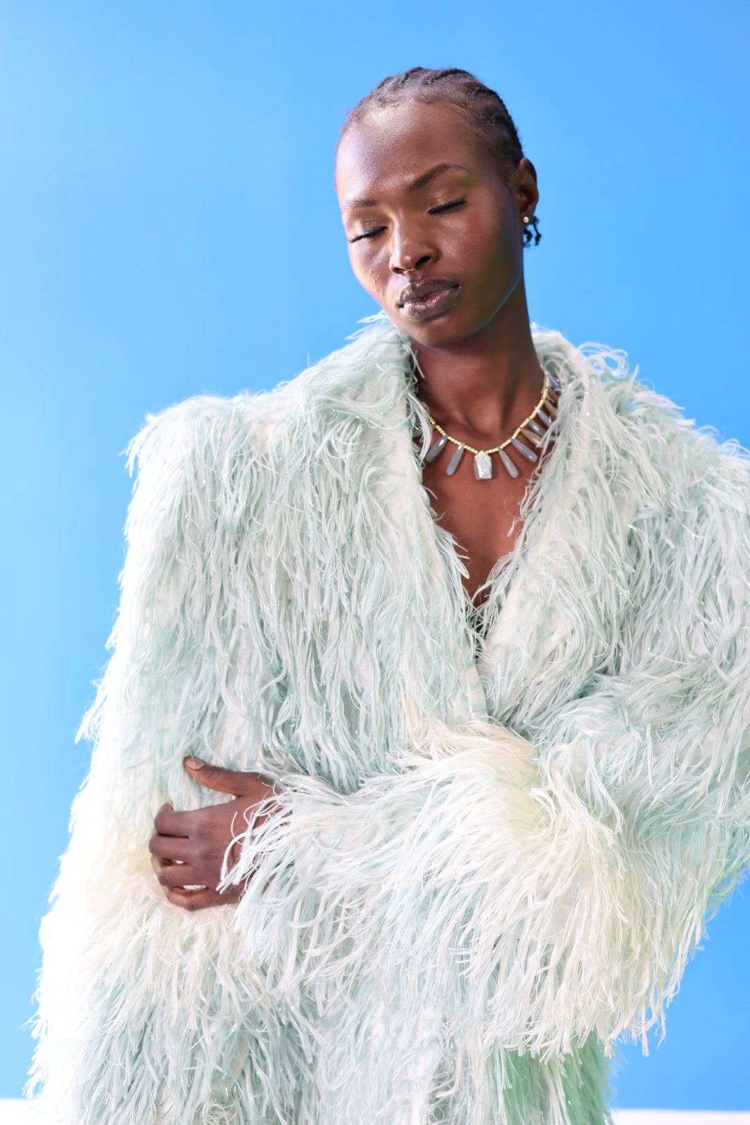 The Enola Shaggy Coat has an ombre effect from light blue to creamy white. The faux fur adds a feeling of luxury to this versatile coat.