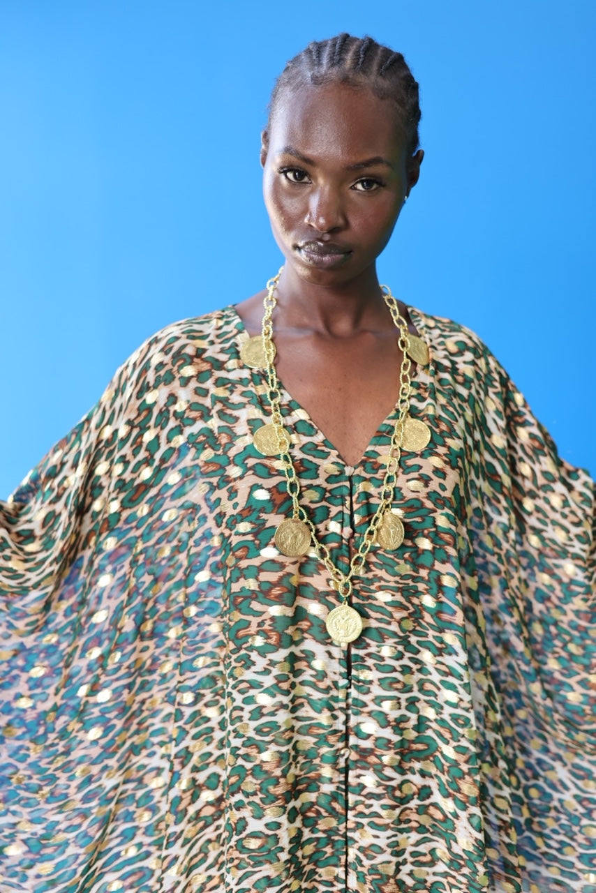 The Joanna Kaftan is a forest green and beige cheetah print kaftan with specks of gold through the design. She looks amazing with a wide range of jewelry.