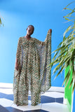 The Joanna Kaftan is a forest green and beige cheetah print kaftan with specks of gold through the design.