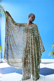 The Joanna Kaftan is a forest green and beige cheetah print kaftan with specks of gold through the design. Her sheer fabric makes for an elegant silhouette.