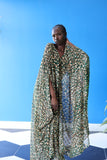 The Joanna Kaftan is a forest green and beige cheetah print kaftan with specks of gold throughout the design.