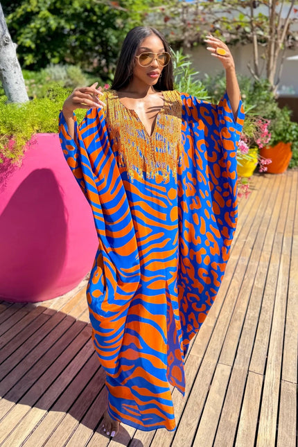 Lisa Box Kaftan by Sai Sankoh in blue and orange animal print with gold beaded neckline